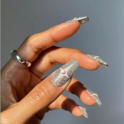 Silver sparkly manicure with baby pink bursts.