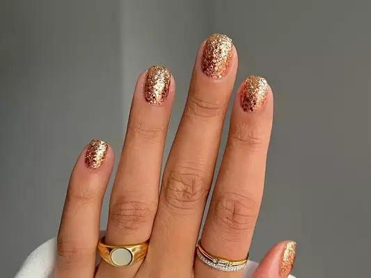 a sparkling glittery gold manicure