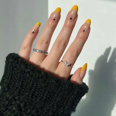 yellow and black dot nails