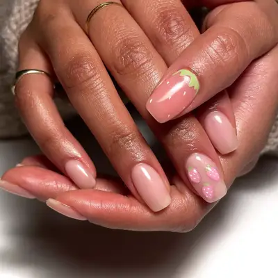 milky strawberry nails with blue heart nail art