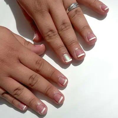 a short classic french manicure topped with chrome