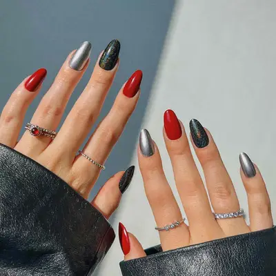 a skittle manicure in shades of silver, red, and holographic black
