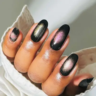 a magnetic aura manicure with a black base