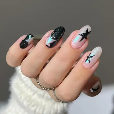 a black sparkle and chrome manicure