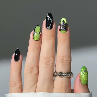 a mismatched manicure with brat green, black, and chrome accents