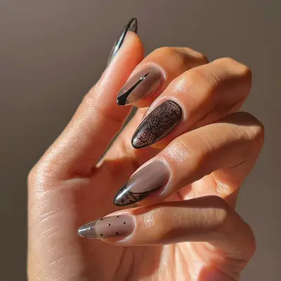 a sheer black manicure topped with pantyhose designs