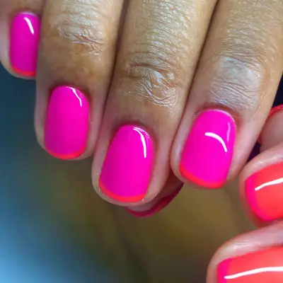 Neon pink nails with micro neon coral French tips