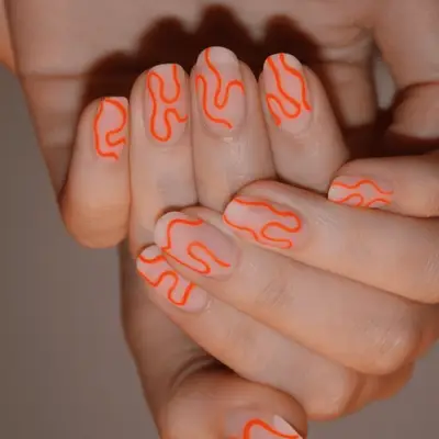 Groovy, colorful 70s nails against a white background