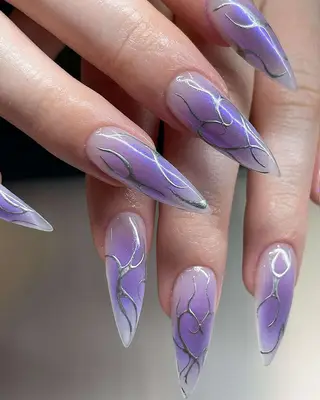 Lavender chrome nails with metallic details.