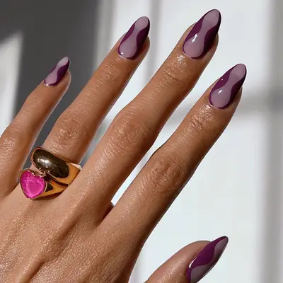 A berry and mauve manicure with swirly details