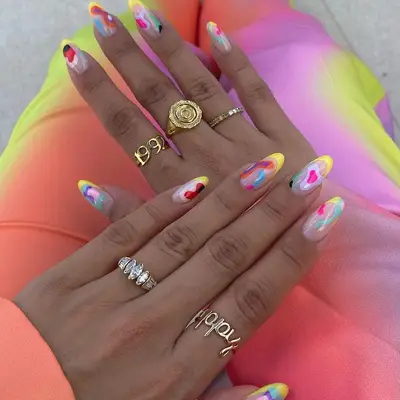melanin rich hairns with a colorful manicure 