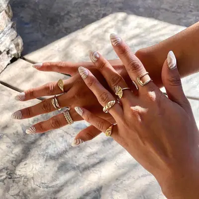 white swirl designed manicure 