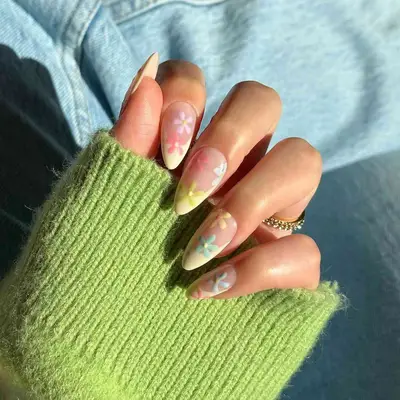 Manicure with butter yellow French tips and colorful floral designs