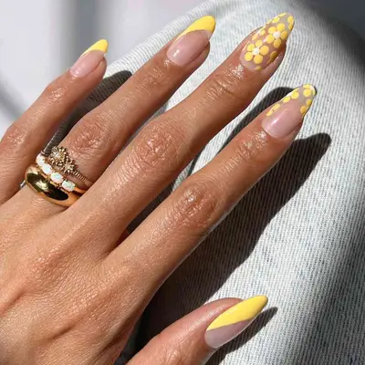 Manicure with yellow diagonal French tips and floral designs