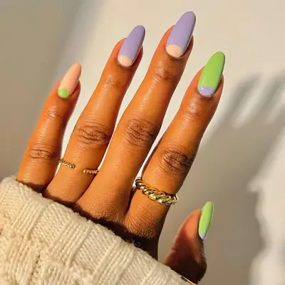 Manicure with purple, green, and peach and cuticle accents