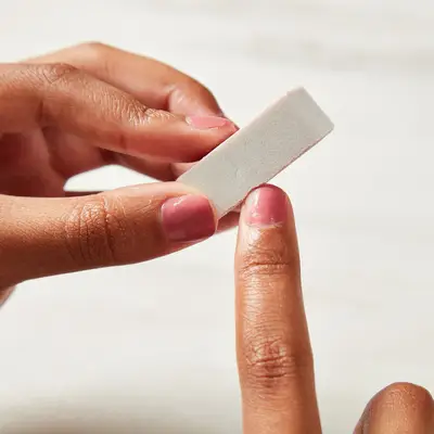 Woman buffing the polish on chipped nail polish