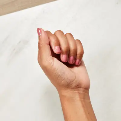 A final look at the repaired nail among the other polished fingers