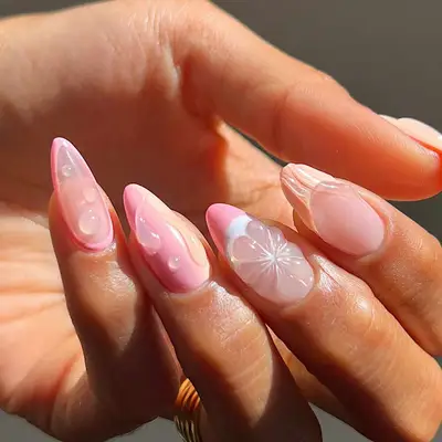 model with pink nails with water 3D details and grapefruit design on middle nail