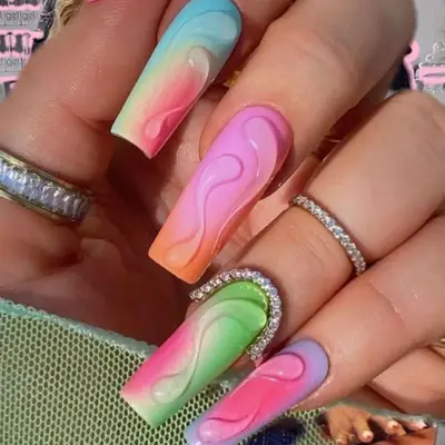 A matte manicure with a pastel ombré base and 3D gel accents