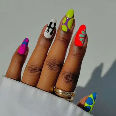 A manicure with abstract designs in bright colors