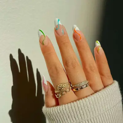 A French manicure with a solid swirl of polish on each finger