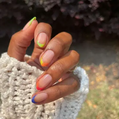 A French manicure with rainbow ombré French tips