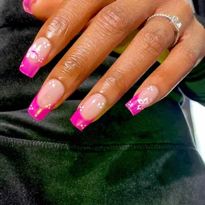 A pink French manicure with hibiscus nail art