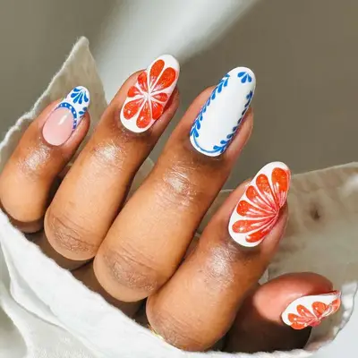 A manicure with porcelain and orange details and designs