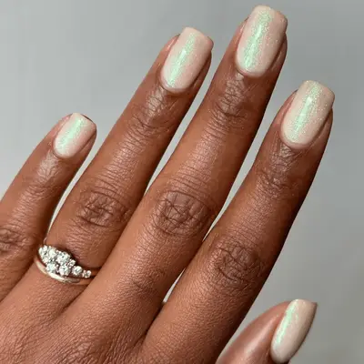 Iridescent glow-in-the-dark shimmery short nails