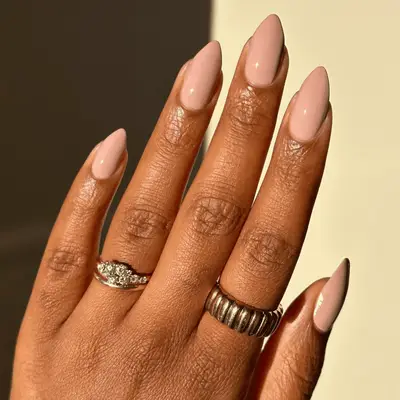 Nude light pink-mauve nails in an almond shape