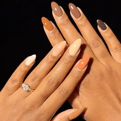 Nude-colored Skittle manicure