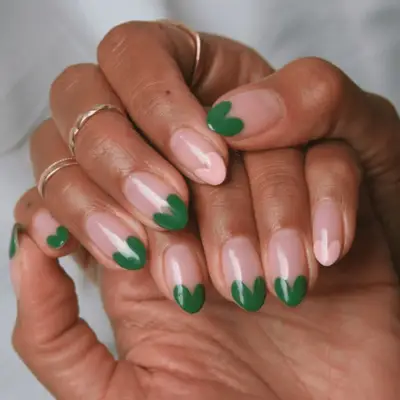 Nude nails with green and pink heart tips