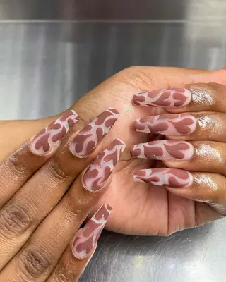 long coffin nails with matte brown hearts 