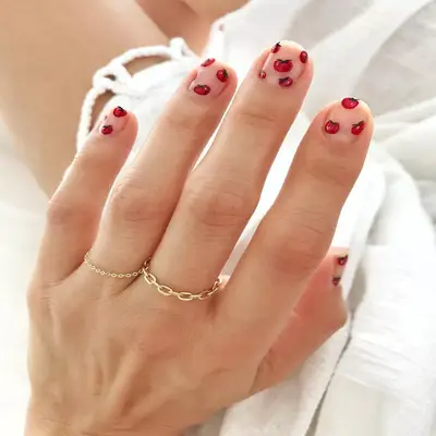 Short nails with mini tomato designs
