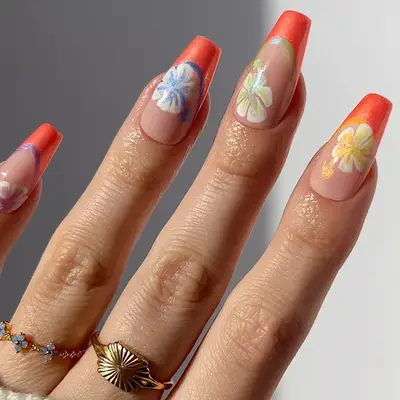 An orange French manicure with hibiscus flower nail art 