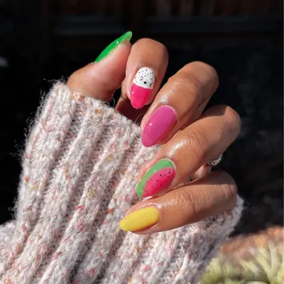 White, pink, and green manicure with wave designs and French tips