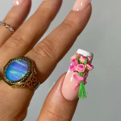 Manicure with neutral base, white French tip, and 3D pink and green rose bouquet design