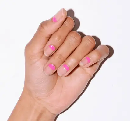 woman with pink minimal manicure against white background