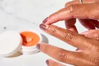 A person applying Dior Crème Abricot Nail Creme to their nail beds