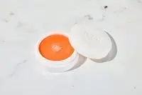 Dior Crème Abricot Nail Creme sitting on a marble counter