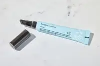 Butter London QuickFix Moisturizing Cuticle Balm sitting on a marble counter