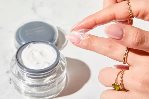 A person applying Dermelect Rejuvenail Treatment to their nail bed