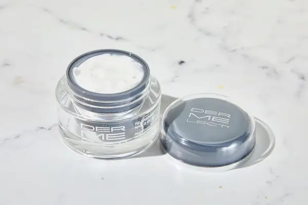 Dermelect Rejuvenail Treatment sitting on a marble counter