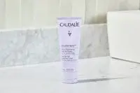 Caudalie Vinotherapist Hand and Nail Cream sitting on a marble bathroom counter