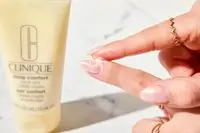 Person tests Clinique Deep Comfort Hand and Cuticle Cream on their fingers