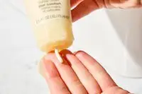 Person dispenses Clinique Deep Comfort Hand and Cuticle Cream into their hand