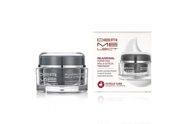 Deborah Lippmann The Cure Cuticle Repair Cream sitting on a marble countertop