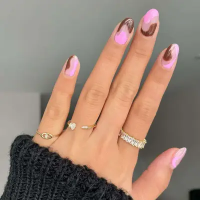 Brown and pink wavy swirl manicure with negative space at center