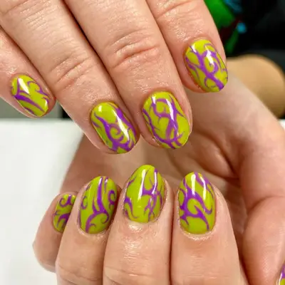 Lime green nails with neon purple swirling flame design