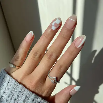 Close-up of manicure with mix-and-match white designs